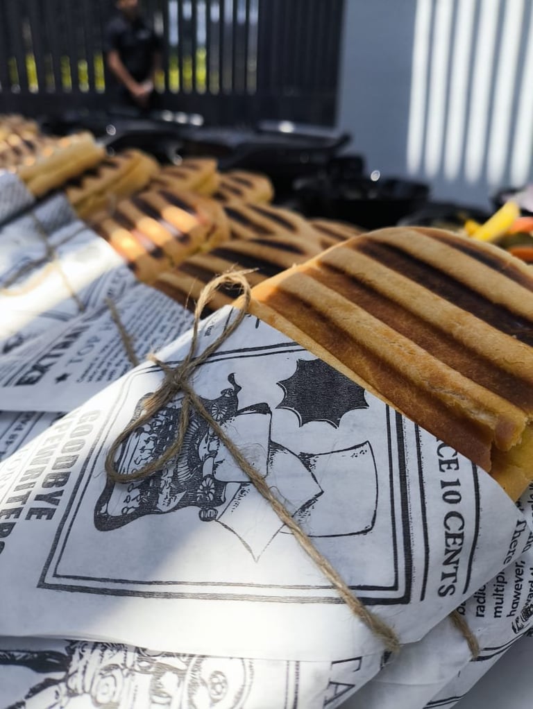 Spider perched on a bat illustration printed on newspaper, with wooden rulers and crates in the background